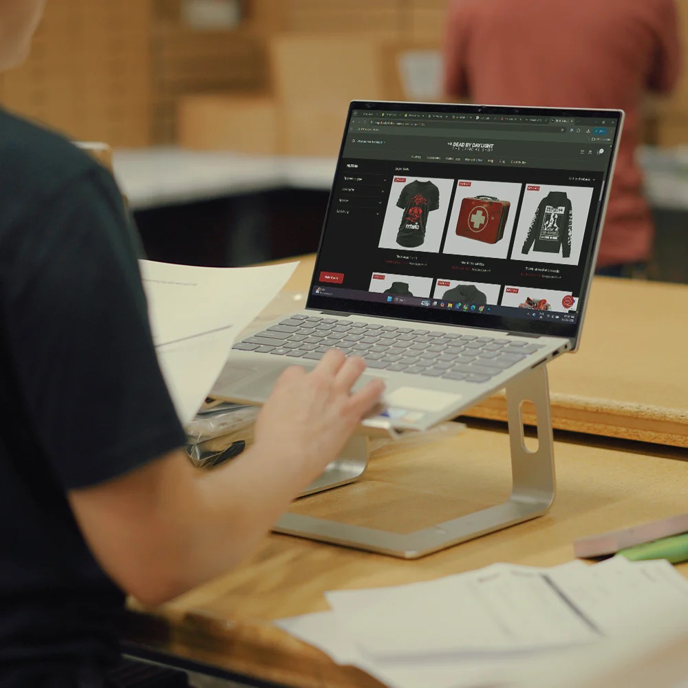 A customer browsing a custom online merch store built by Sound & Fury, stocked with printed tees and hoodies